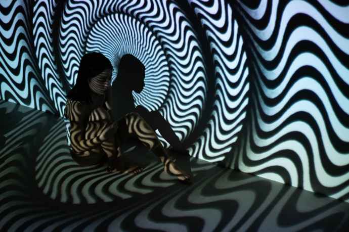 woman sitting on the floor with black and white wavy stripes